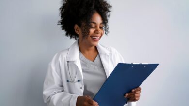 medium shot smiley doctor wearing white coat3 scaled